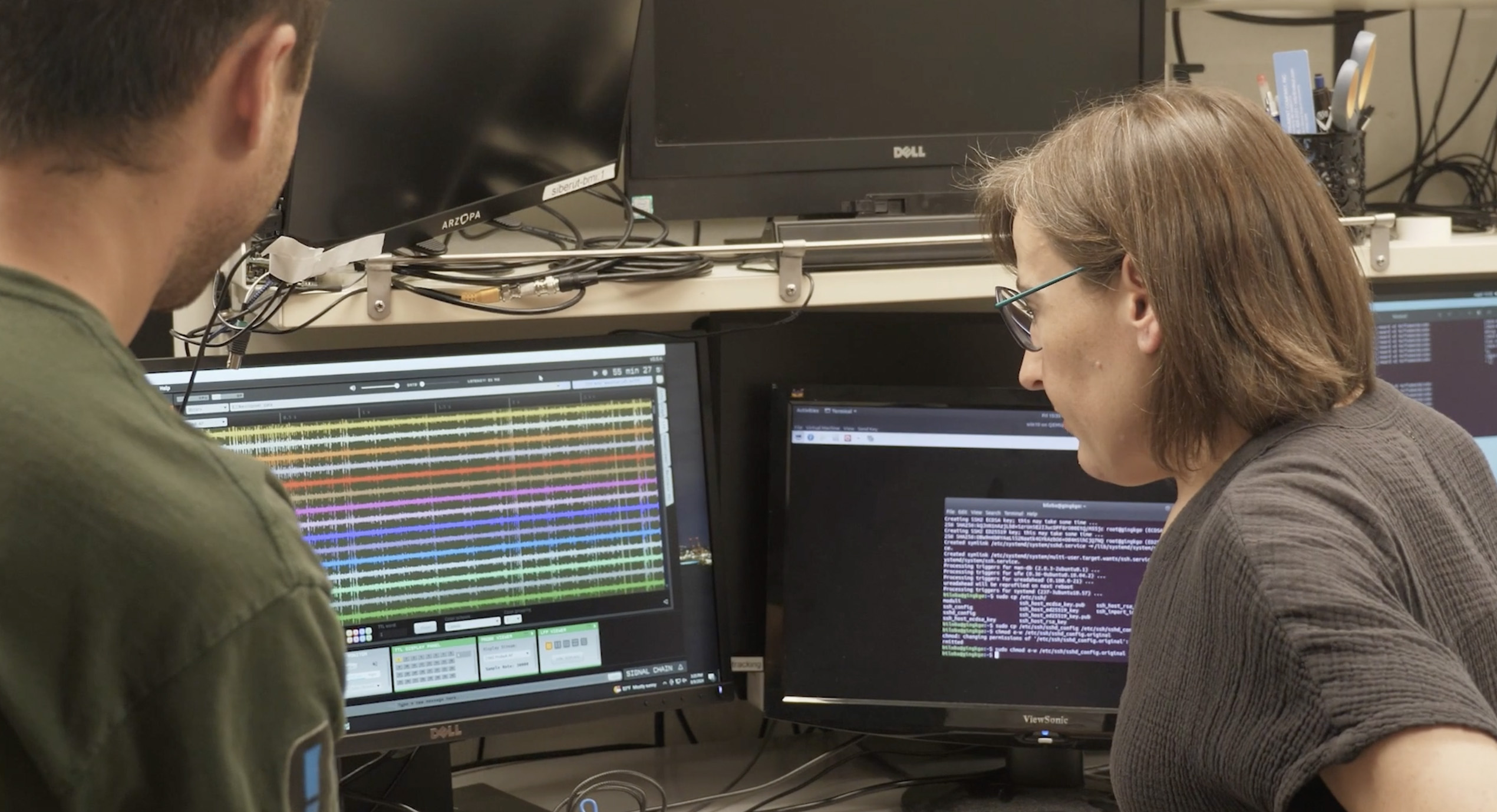 A futuristic control room with multiple data screens.